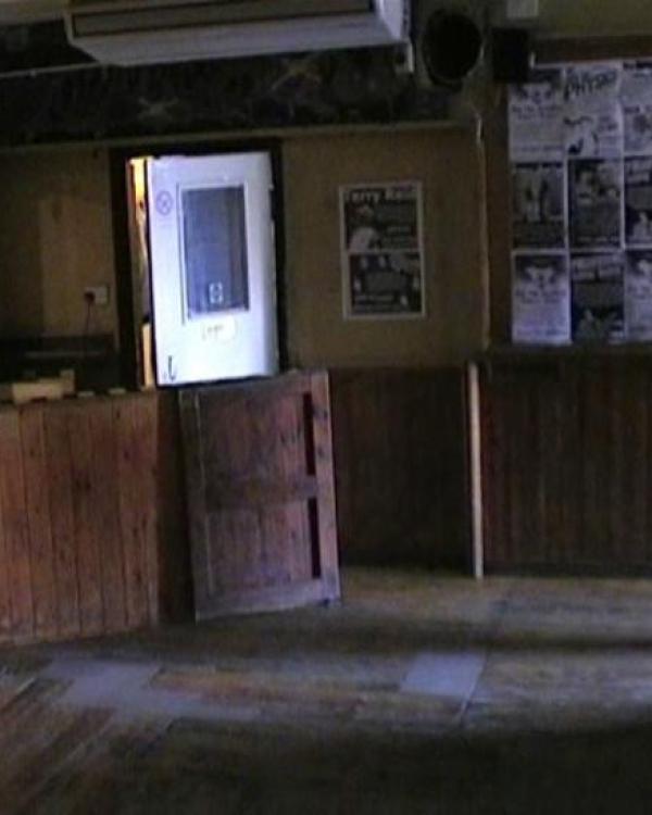 Fenced-off end of bar and kitchen/office door