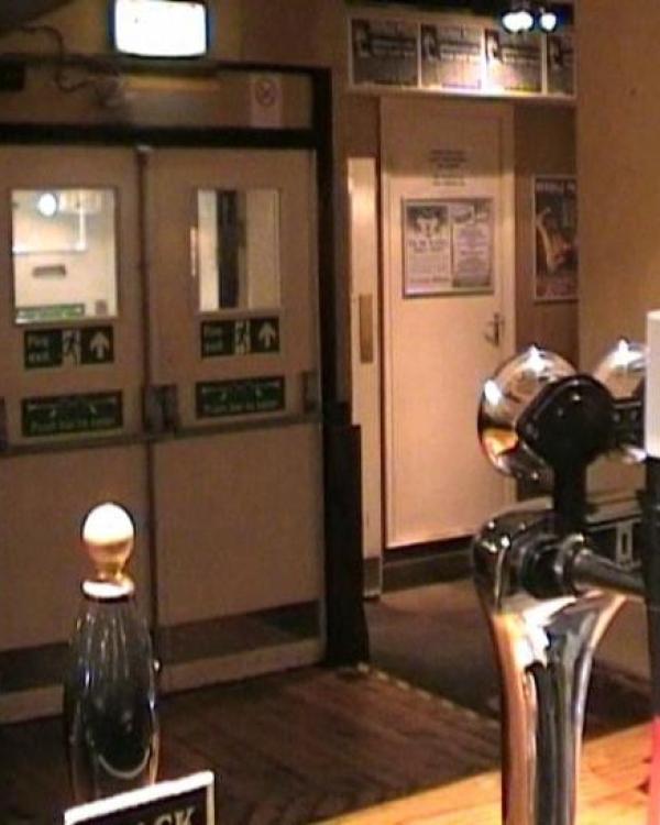 View of front doors and box office door from the bar